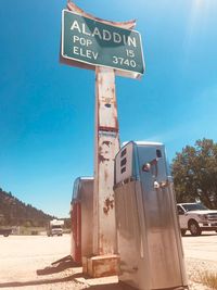 Information sign on road against blue sky