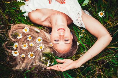 High angle view of woman lying down on field