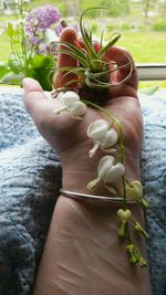 Cropped image of woman with white bleeding hearts