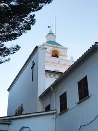 Low angle view of bell tower against sky