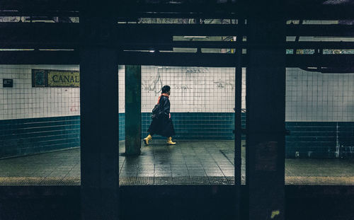 Full length of woman standing by railing