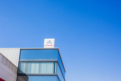 Low angle view of building against clear blue sky