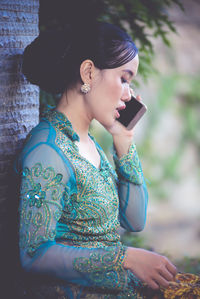 Young woman using mobile phone outdoors