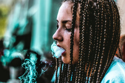 Close-up of young woman smoking cigarette