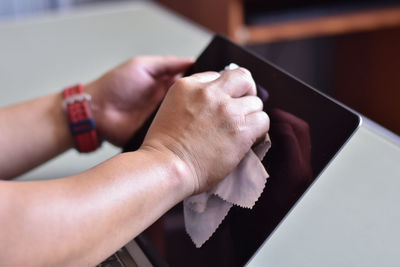 Close-up of woman hand on table