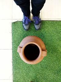 Low section of woman standing on tiled floor