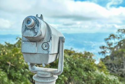 Close-up of security camera against sky