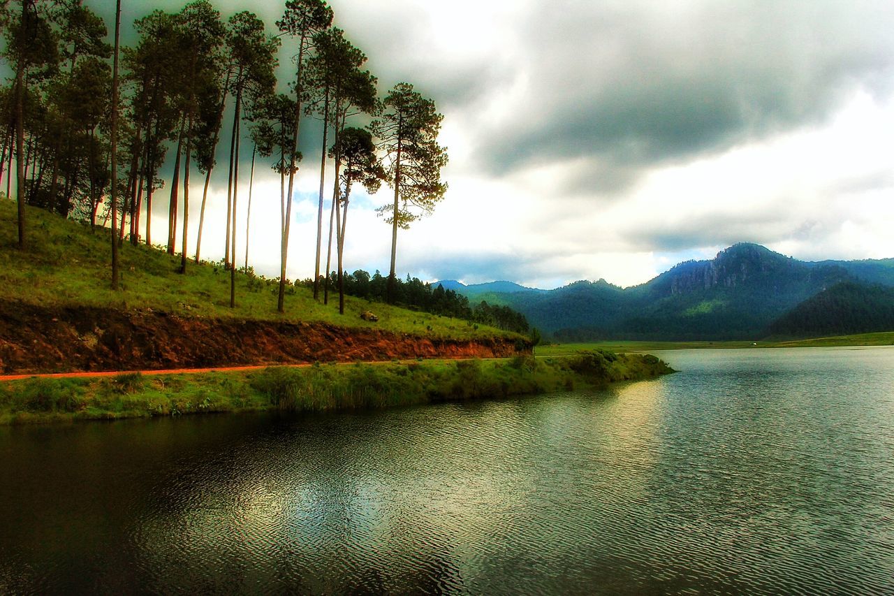 sky, tranquil scene, water, tranquility, cloud - sky, scenics, cloudy, beauty in nature, tree, nature, cloud, lake, landscape, river, overcast, rippled, idyllic, grass, waterfront, non-urban scene