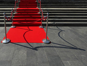 High angle view of red shopping cart on footpath