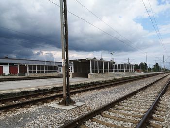 Train at railroad station against sky