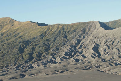 Scenic view of arid landscape against clear sky