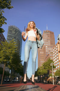 Woman levitating against buildings