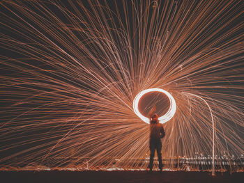 Low angle view of fireworks at night