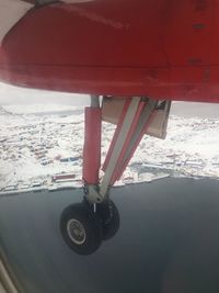 Airplane on snowcapped mountains during winter