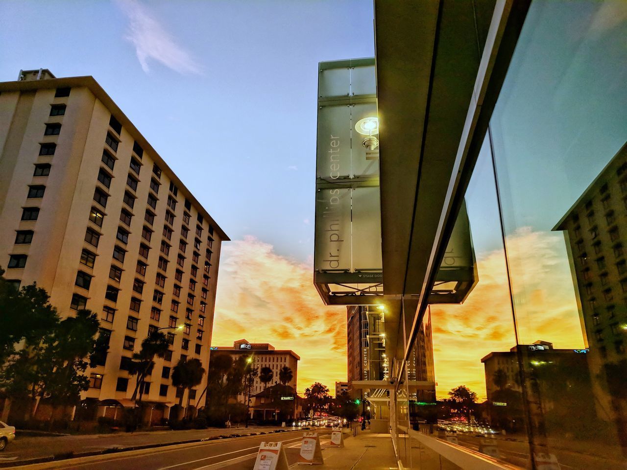 ROAD AMIDST CITY AGAINST SKY