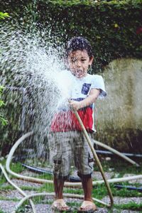 Full length of boy standing in water