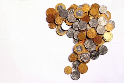 High angle view of coins on white background