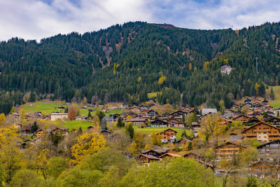 Scenic view of townscape and mountains against sky