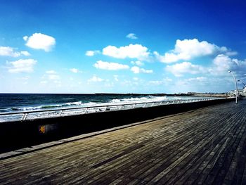 Scenic view of beach against blue sky