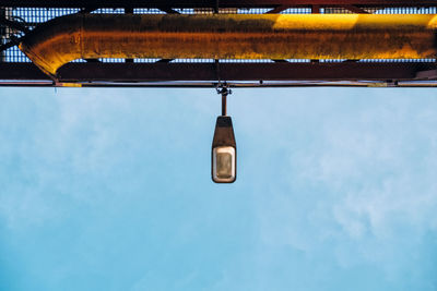 Low angle view of illuminated street light against sky