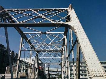 Low angle view of bridge against blue sky