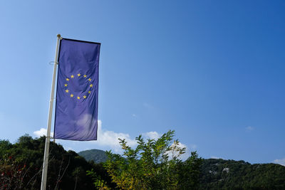 Low angle view of european union flag against blue sky