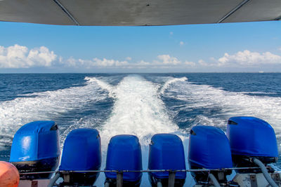 Speedboat moving in sea against sky