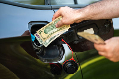 Cropped hand of man repairing car