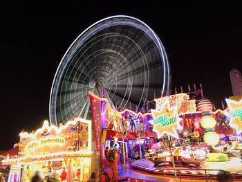 Low angle view of illuminated ferris wheel at night