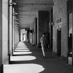 Rear view of woman walking in corridor