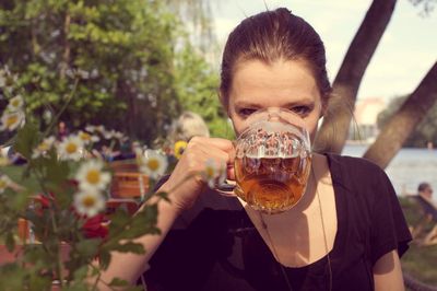 Portrait of woman drinking beer