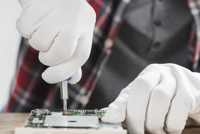 Midsection of man holding syringe