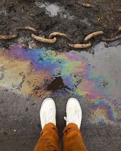 Low section of man standing on road