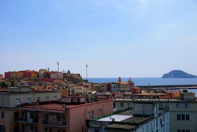 High angle view of town by sea against clear sky