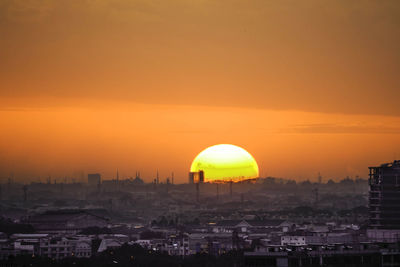 Buildings in city during sunset