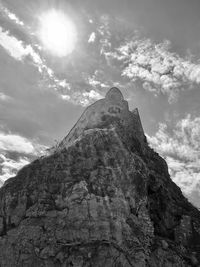 Low angle view of rock formation against sky on sunny day