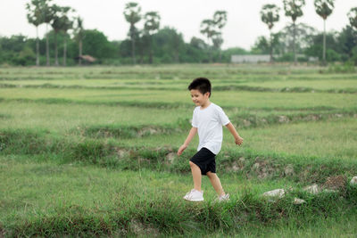 Full length of boy standing on field