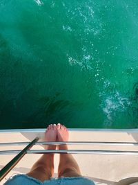 Low section of woman in boat in sea