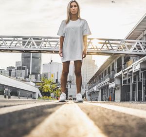 Full length of woman standing on road in city