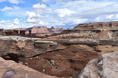 View of rock formations against cloudy sky