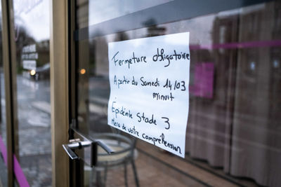 Close-up of text on glass window