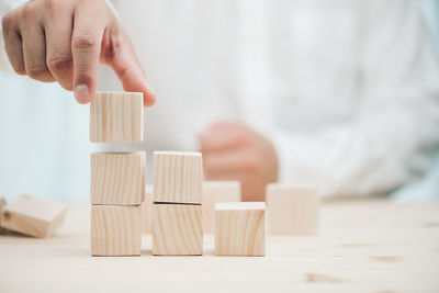 Midsection of person playing with toy on table