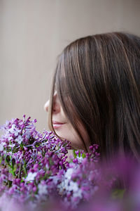 Close-up portrait of woman with pink flower