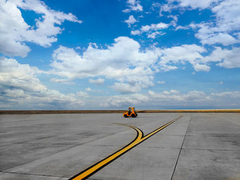 Man on road against sky