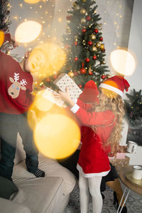 Low section of woman holding christmas tree