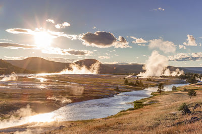 Steam rising from hot springs of midway geyser basin in yellowstone national park, wy, usa.