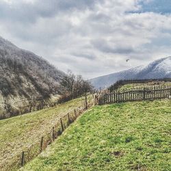 Scenic view of landscape against cloudy sky