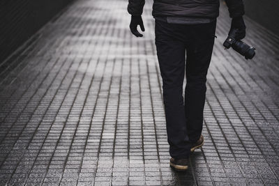 Low section of man walking on footpath