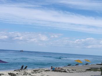 People on beach against sky