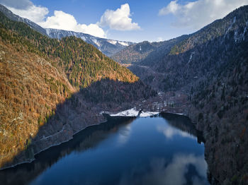 Scenic view of lake and mountains against sky